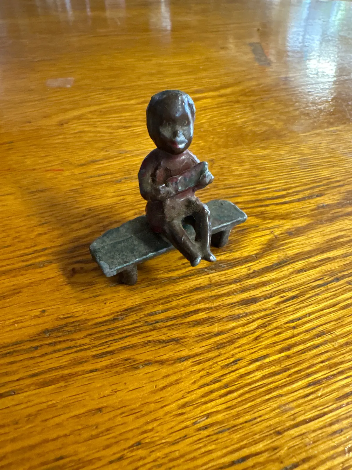 Lead Black Americana Boy Sitting On Bench 1