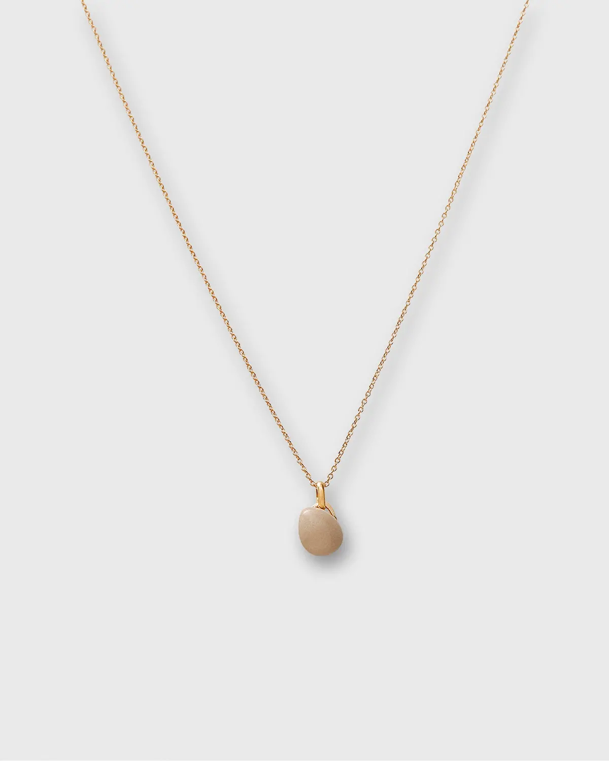 Tiny Ceramic Egg Pendant Necklace In Almond/Gold 1